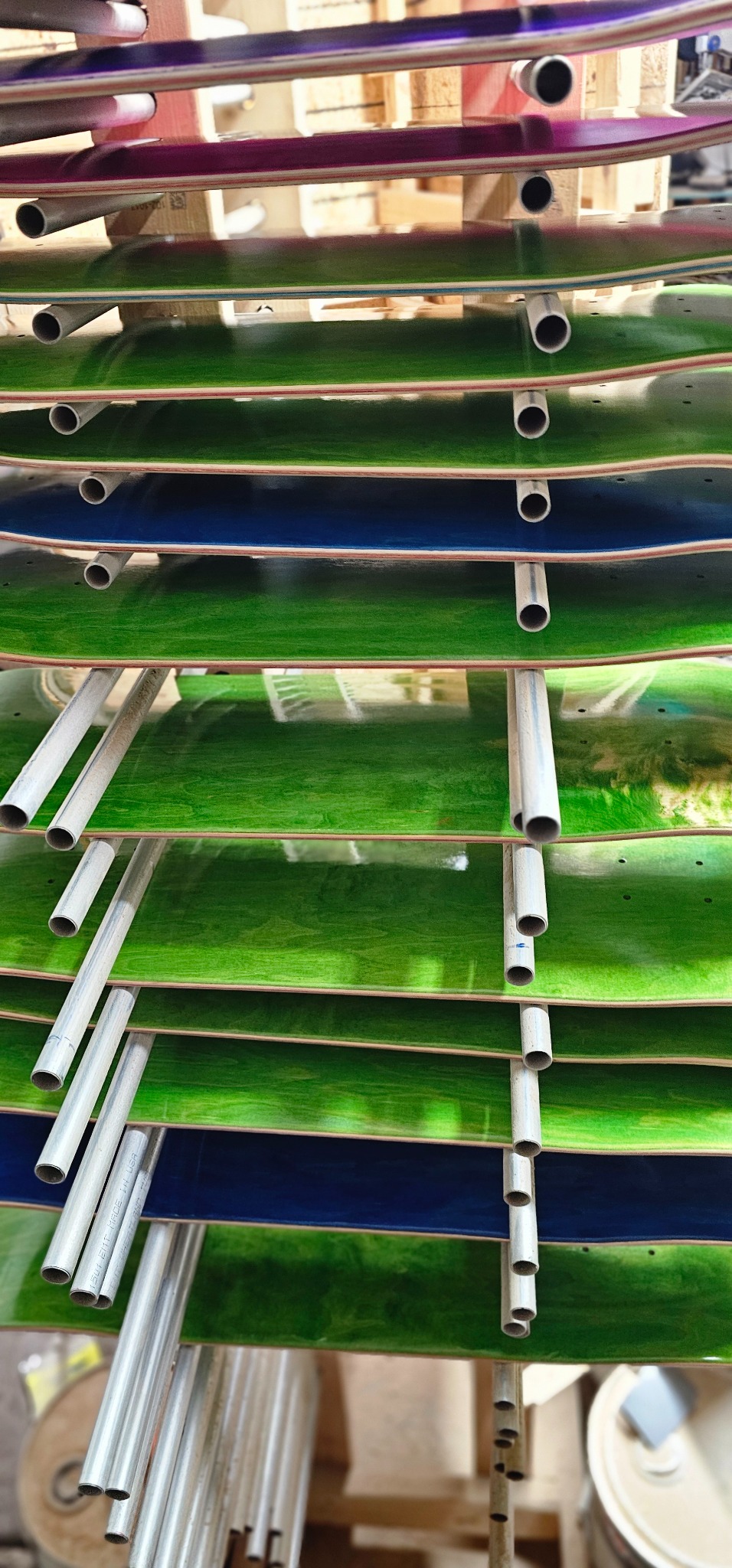 Glossed green skateboard decks ready in the racks
